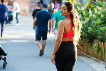 Pretty woman wearing sportswear looking back over her shoulder
