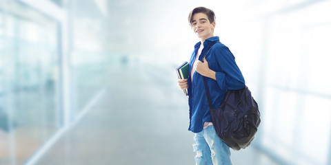 student with backpack and books at college or university