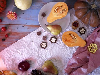 Preparation of pumpkin, fruit and chocolate dessert for a festive seasonal dinner, decorative still life, top view