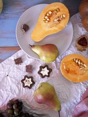 Preparation of pumpkin, fruit and chocolate dessert for a festive seasonal dinner, decorative still life, top view