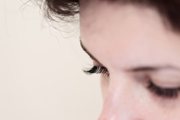 Closed woman eyes with long eyelashes