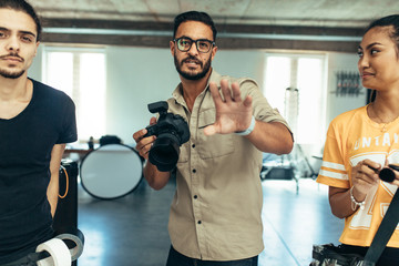Photographer with his team during a photo shoot in a studio