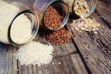 A mix of cereals - buckwheat, ots, white rice, rustic wooden table