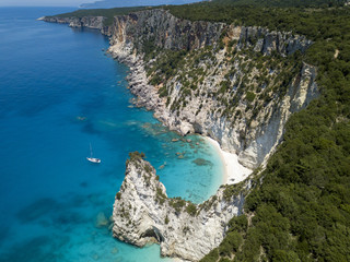 Aerial photo over greek island boat cliffs coastline landscape