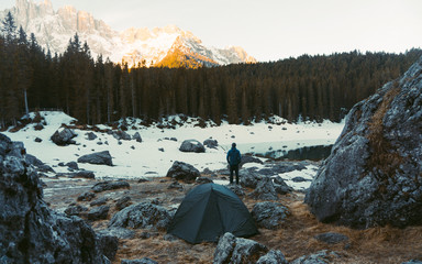  Alone tourist and sporty outdoor clothes in blue jacket. Mountain view from morning in snowy...