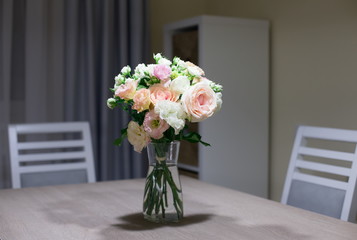 Interior. Bouquet roses on the kitchen table