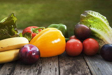 Fresh colorful vegetables ingredients fo vegan and healthy cooking or salad making on rustic background, top view, frame. Copy space.