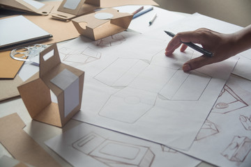 Designer sketching drawing design Brown craft cardboard paper product eco packaging mockup box...