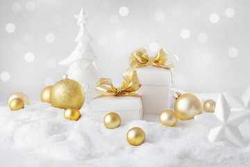 Fototapeta na wymiar christmas ornaments and gift box on the snow