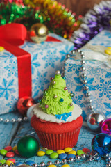 Christmas cupcake with colored decorations, soft focus background