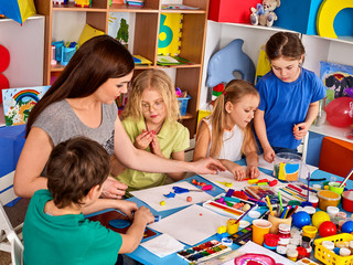 Child dough play in school. Homemade playdough and plasticine for children in kindergarten. Kids...