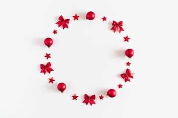 Christmas composition. Xmas wreath of red decoration and cones on white background. Flat lay, top view, copy space 