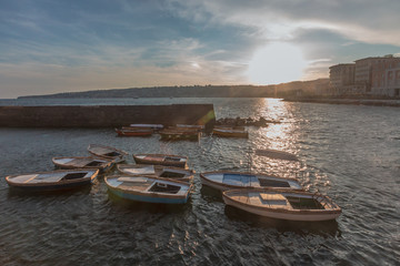 Coast and buildings of Naples, Italy at sunset