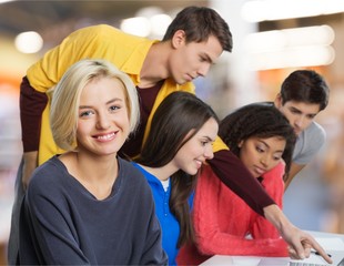 Young students studying on background