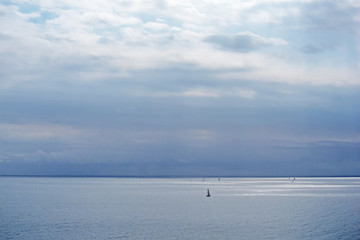 Fototapeta na wymiar Calm blue sea with sailboats