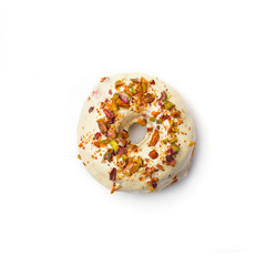 Donut with white cream and hazelnut core, isolated on white background. Top view.