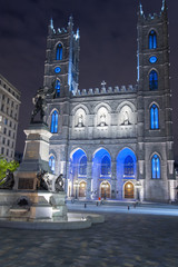 Fototapeta na wymiar Place D'armes with Maisonneuve Monument and Notre Dame Basilica at night