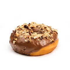 Donut with chocolate glaze with milk and peanuts, isolated on white background. View from side.