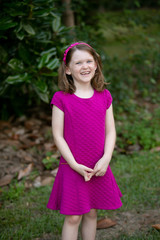 Happy Little Girl in Pink Dress Outside	