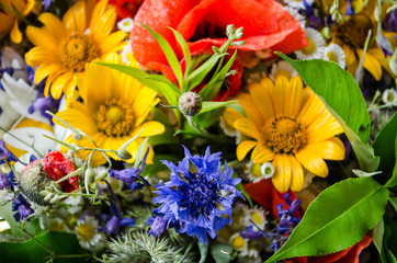 luxuriant summer bouquet of wildflowers with poppies, daisies, cornflowers closeup.