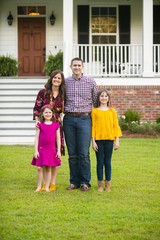 Family of Four Outside their New Construction Home