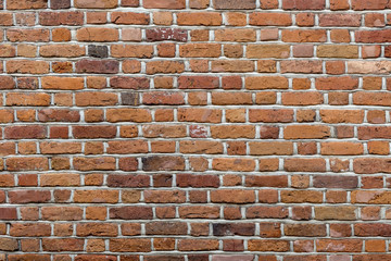 Natural old vintage weathered red brown solid brick wall. Abstract copy space background.
