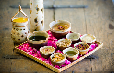 Ayurvedic spa beauty massage treatment with fresh natural ingredients in bols
