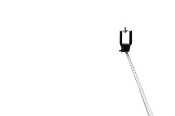 Selfie stick and smartphone on an isolated white background