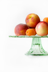 Glass plate with peaches, apricots and nectarines