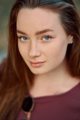 Smiling young woman closeup portrait outdoors