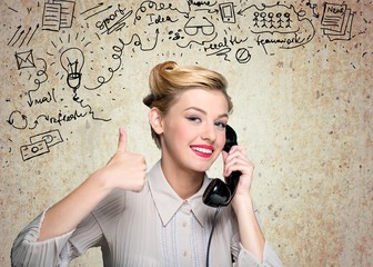 Attractive young woman working on vintage typewriter