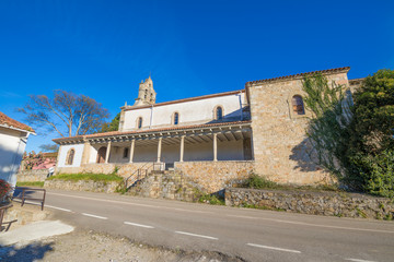 Fototapeta premium side view of church San Esteban de Leces, old romanic temple rebuilt in year 1958, next to pilgrim hostel on Camino de Santiago, near Ribadesella, Asturias, Spain