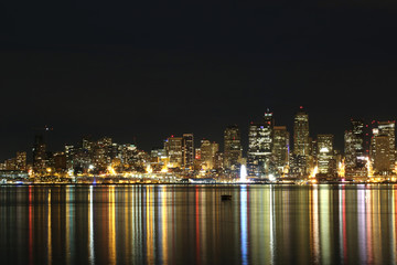 Colorful Seattle City scape at night reflected in water