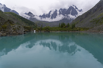 Fototapeta na wymiar Reflection of mountains in the water. Altai Mountains, Russia.