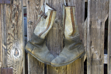 Old boots hanging on a wooden fence in Hungary