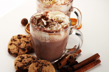 Hot chocolate cocoa with whipped cream on table.
