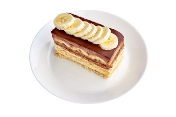 Banana cake on plate isolated on white background. Sweet dessert. Close up.
