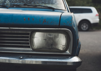 Fototapeta na wymiar Front view of blue rusty old automobile