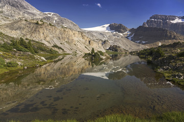 Fototapeta na wymiar Wilderness lake and snowy mountain peaks near Crowfoot Glacier on Icefields Parkway in Banff National Park Rocky Mountains Alberta Canada
