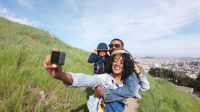 Family takes photo on San Francisco hillside, POV