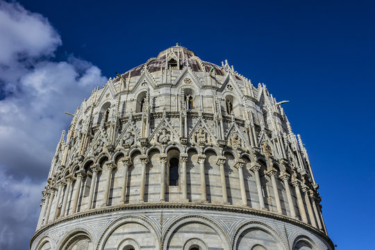 The Baptistery of St. John (Battistero di San Giovanni, 1363) at Piazza dei Miracoli (Square of Miracles) in Pisa. Baptistery is Unesco world heritage site. Pisa, Tuscany, Italy, Europe.