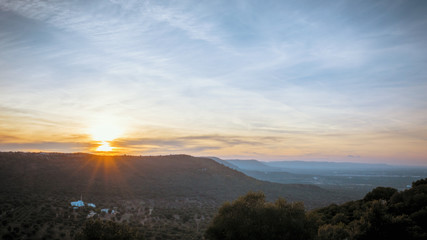 Stunning sunset on the hills between Ostuni and Cisternino with panoramic view on the expanses of olive trees of the plain of Fasano