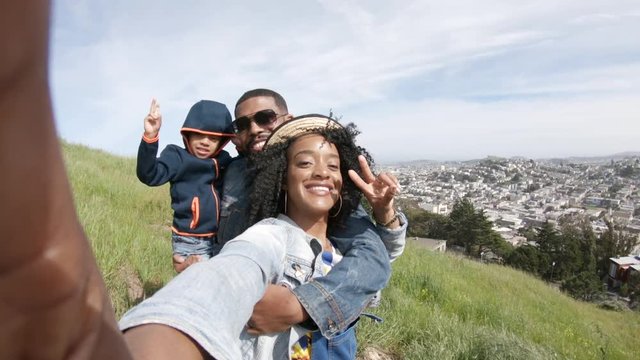 POV, family takes selfie on San Francisco hillside