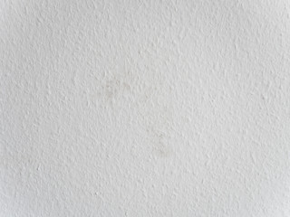 Close up of freshly painted white wall with dirt spots on ingrain or woodchip wallpaper or so called Raufasertapete, the most typical wall design in Germany