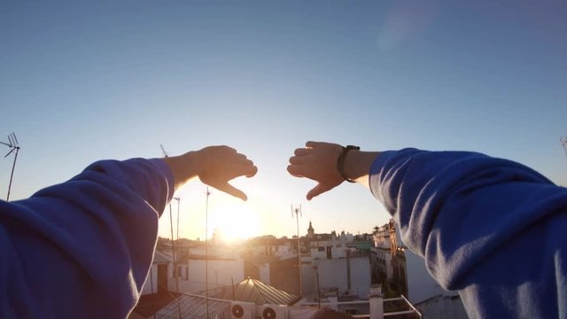 Sunset over rooftops in Spain, tilt up POV