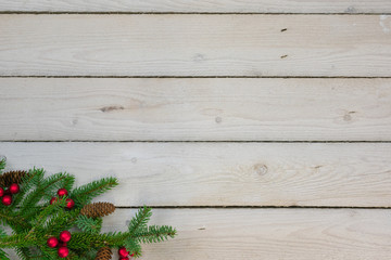 Holiday border with greenery in the bottom left corner with copy space