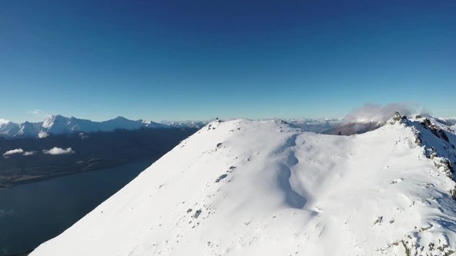 Snowy mountain peak, wide aerial
