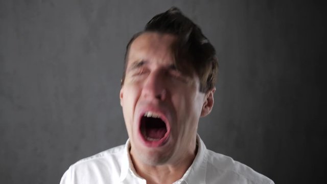 Portrait of sad man crying with tears in eyes. Depressed businessman crying. Man in despair.