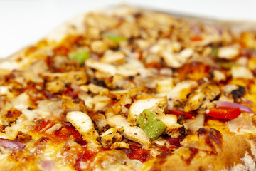 Close up of a slice of blackened chicken pizza