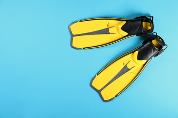 Swimming flippers on color background, top view. Space for text © New Africa